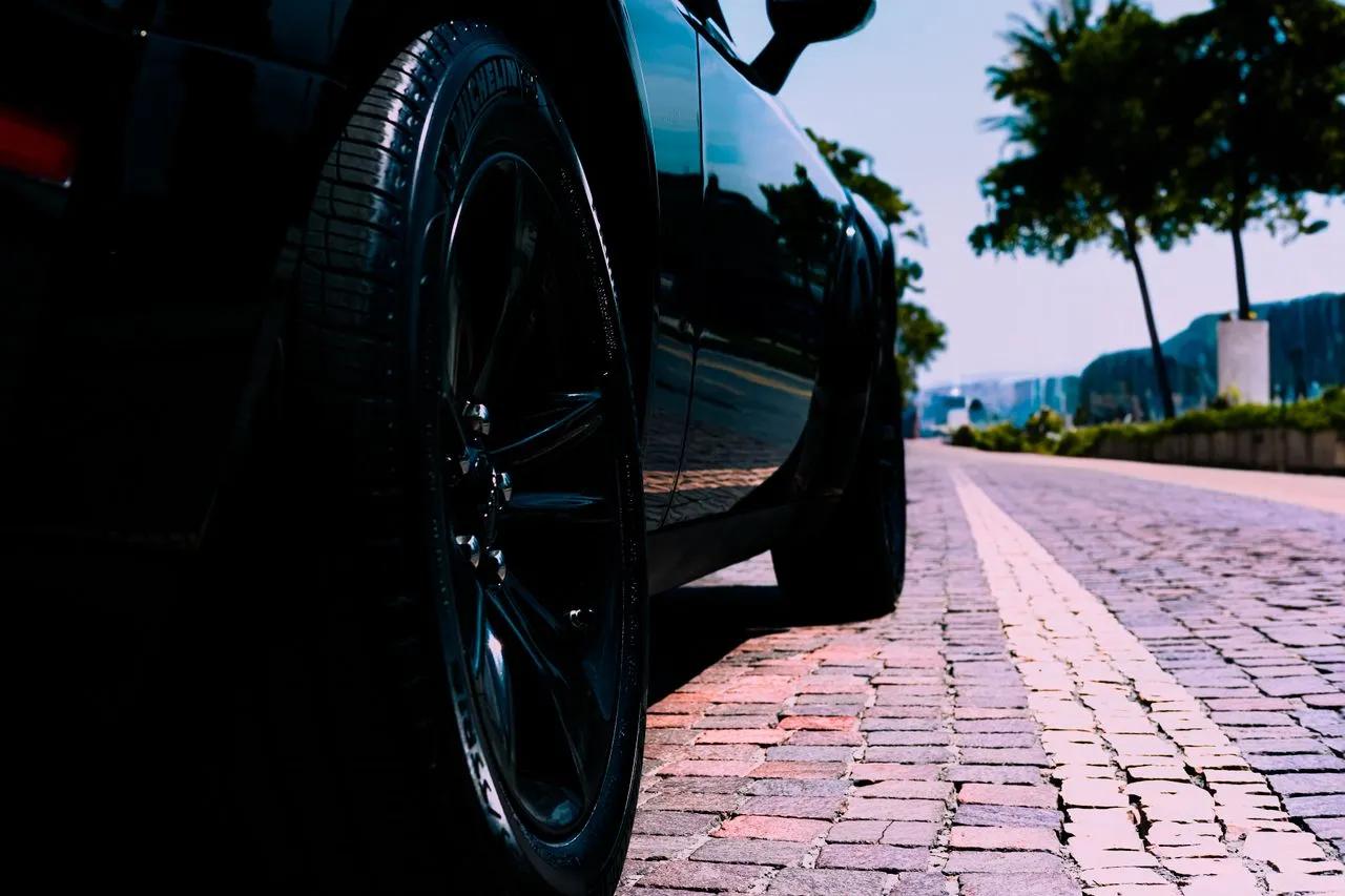 Mechanic inspecting car tires