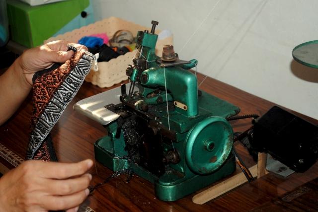 Embroidery specialists combine creativity and skill to craft fabric designs. cover picture