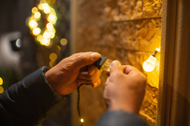 Man decorating house for Christmas