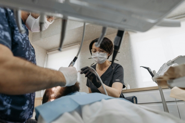 A dentist placing a dental implant