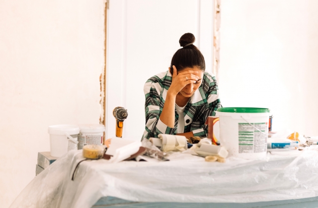 young woman feeling stressed over doing home repairs