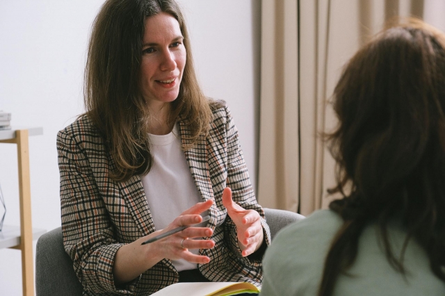 Photo by SHVETS production: https://www.pexels.com/photo/positive-woman-sitting-with-notebook-and-talking-with-female-7176288/