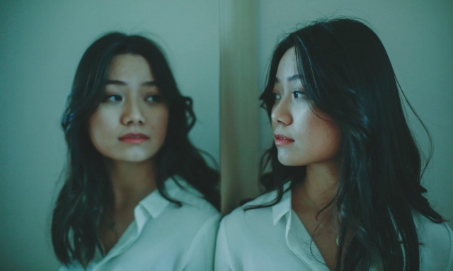 Photo by JESSICA TICOZZELLI: https://www.pexels.com/photo/young-asian-female-looking-at-reflection-4333559/