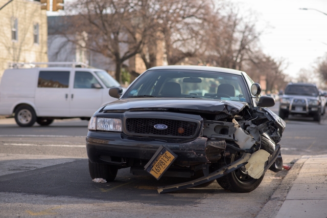 a black car with a damaged front end