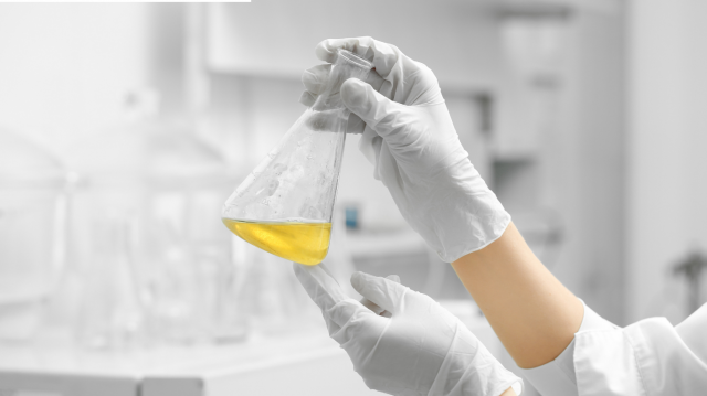 person doing experiments with Industrial grade chemical in flask