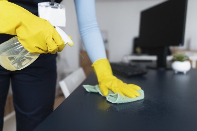 person cleaning a desk