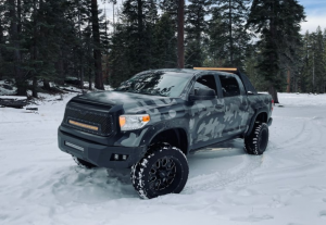A Lifted Truck on a snow filled road