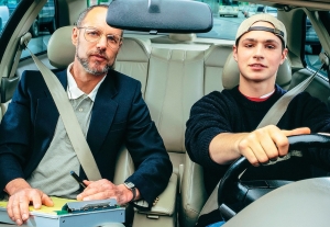 a driving instructor giving instructions to his student