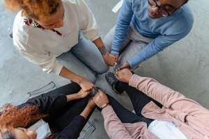 Photo by Antoni Shkraba Studio: https://www.pexels.com/photo/high-angle-shot-of-people-holding-each-other-s-hands-7579304/