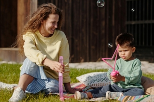 Photo by Werner Pfennig: https://www.pexels.com/photo/mother-and-son-sitting-on-the-grass-5445219/