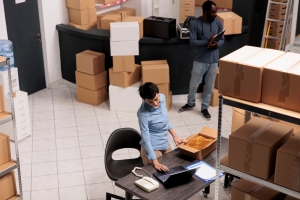 Office Movers and Packers professionals meticulously preparing boxes and verifying inventory for a seamless office relocation.