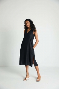 Mood shot of lady in midi black dress which is from reistor