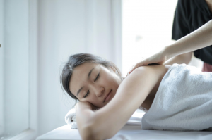  woman getting a back massage as she sleeps