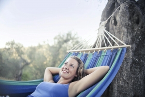 Photo by Andrea Piacquadio: https://www.pexels.com/photo/woman-in-blue-tank-top-lying-on-blue-hammock-smiling-3771840/
