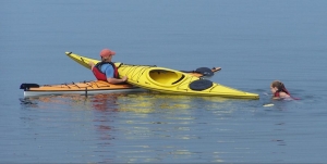 How do I rescue myself or others in case of a capsized kayak?