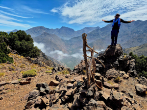  a person posing with his arms open at the top of the mountain