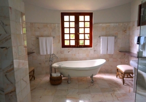 Photo by William LeMond: https://www.pexels.com/photo/white-bathtub-on-white-tile-bathroom-near-brown-framed-clear-glass-window-105934/