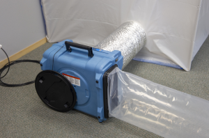 How do restoration services use negative air pressure for containment?