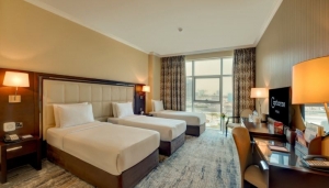 How spacious are the deluxe rooms compared to standard rooms?