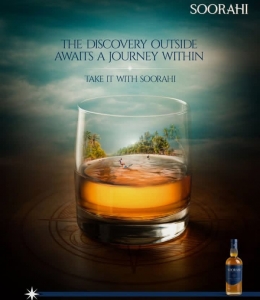 premium blended whisky glass with a tropical island reflection inside, promoting discovery and adventure, with a bottle of Soorahi whisky