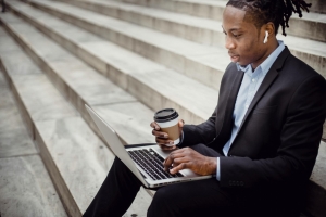 Photo by Ketut Subiyanto: https://www.pexels.com/photo/crop-content-black-businessman-typing-on-laptop-on-stone-stairs-4559673/