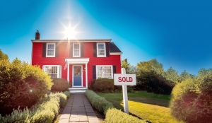 suburban home with a sold sign in front