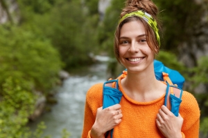 A happy young woman enjoying a digital detox vacation