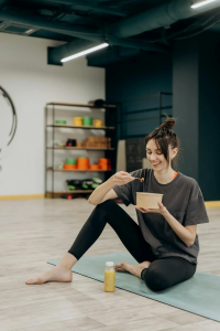 A woman enjoys a bowl of food with mushroom extract.