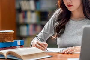 Asian young student hand writing homework