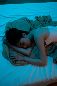 An image of a woman lying on the bed  