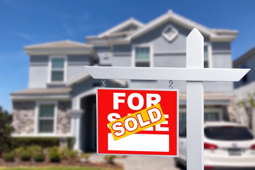 suburban home with for sale sign has been sold
